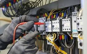 Electrician testing electrical panel